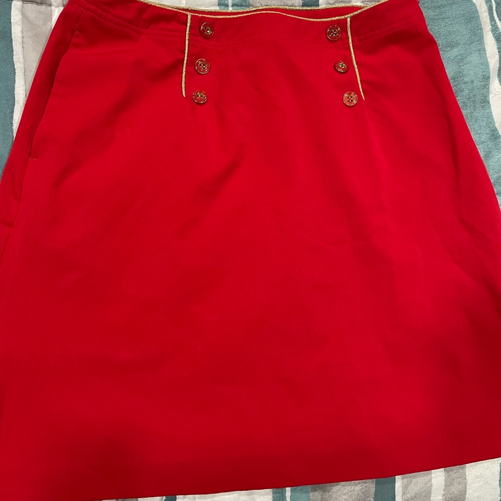 Red skirt , gold outlining , 6 front buttons , back pocket